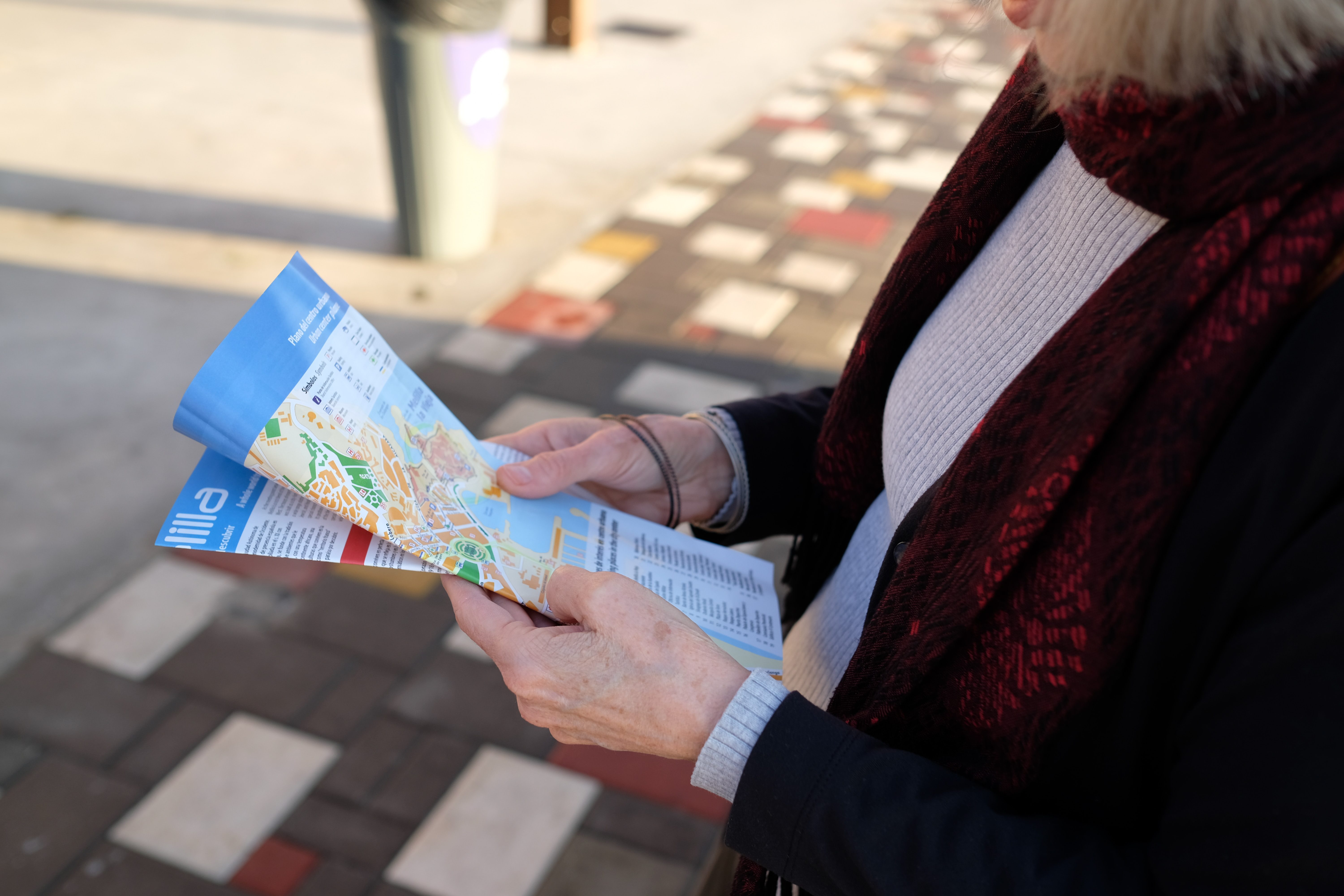 Airbnb guest holding a local neighbourhood map provided by the host